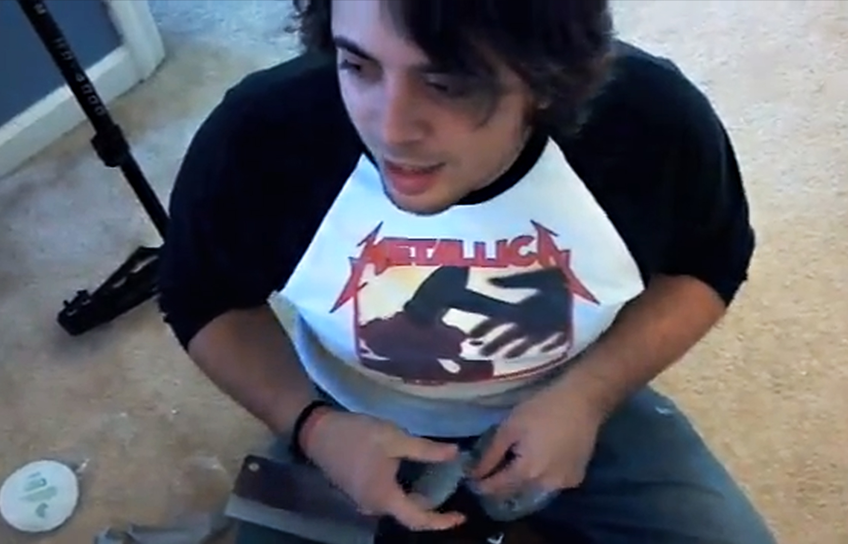 Cory duct-taping the knife on set, completely aware of the ironic wardrobe choice.