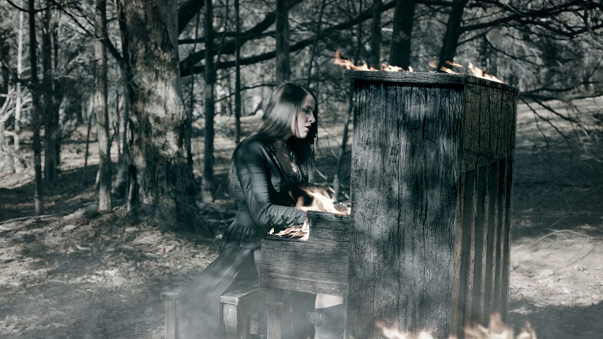 mackenzie morrow playing a piano on fire in the official music video for “Experimental”