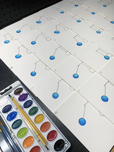 Most of the 28 drawings with the first sphere painted blue