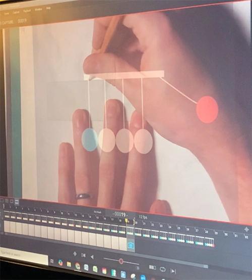 Tracing a digital animation onto paper, using the computer screen to show the overlay