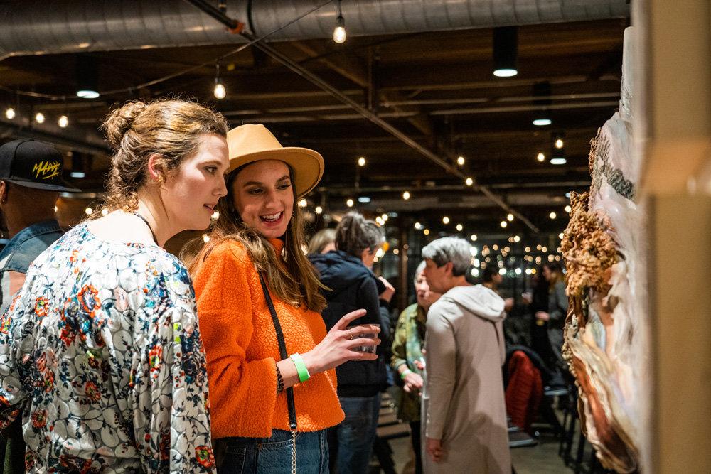 Attendees at Local Takes film premiere explore the art gallery